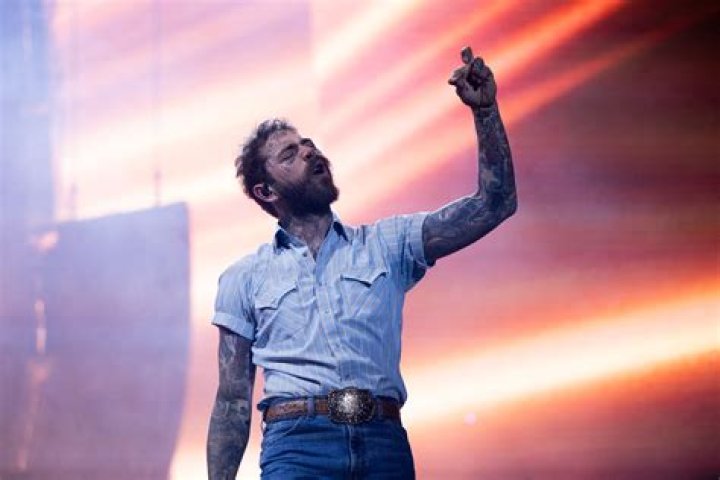 Singer Post Malone is caught in a rare display of affection with